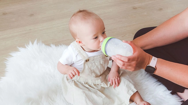 Mom feeding her baby NeuroPro Sensitive