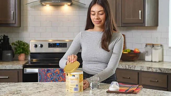 Mom making Enfamil NeuroPro Infant formula