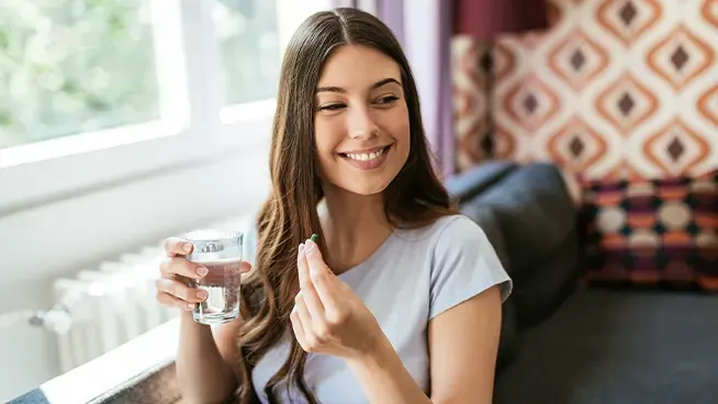 Woman about to take prenatal vitamin