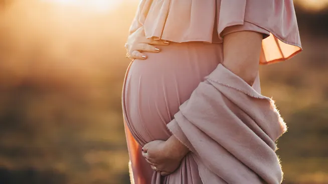 Woman posing during maternity photoshoot