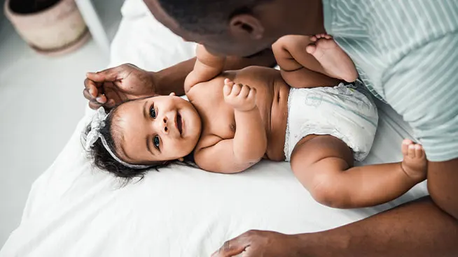 Dad playing with baby