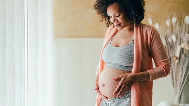 Pregnant woman holding her belly