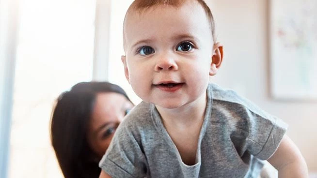 Baby crawling and looking at the camera