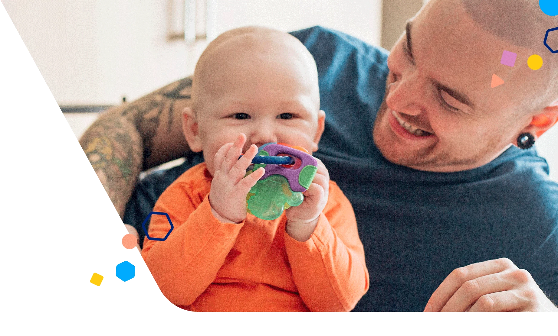 Dad giggling with baby as baby chews on a teething ring