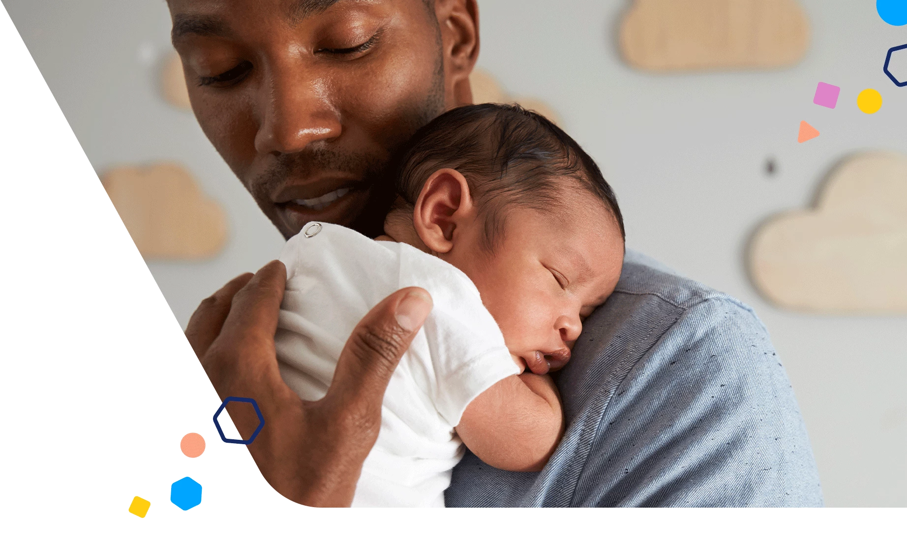 Dad holding sleeping newborn in the nursery