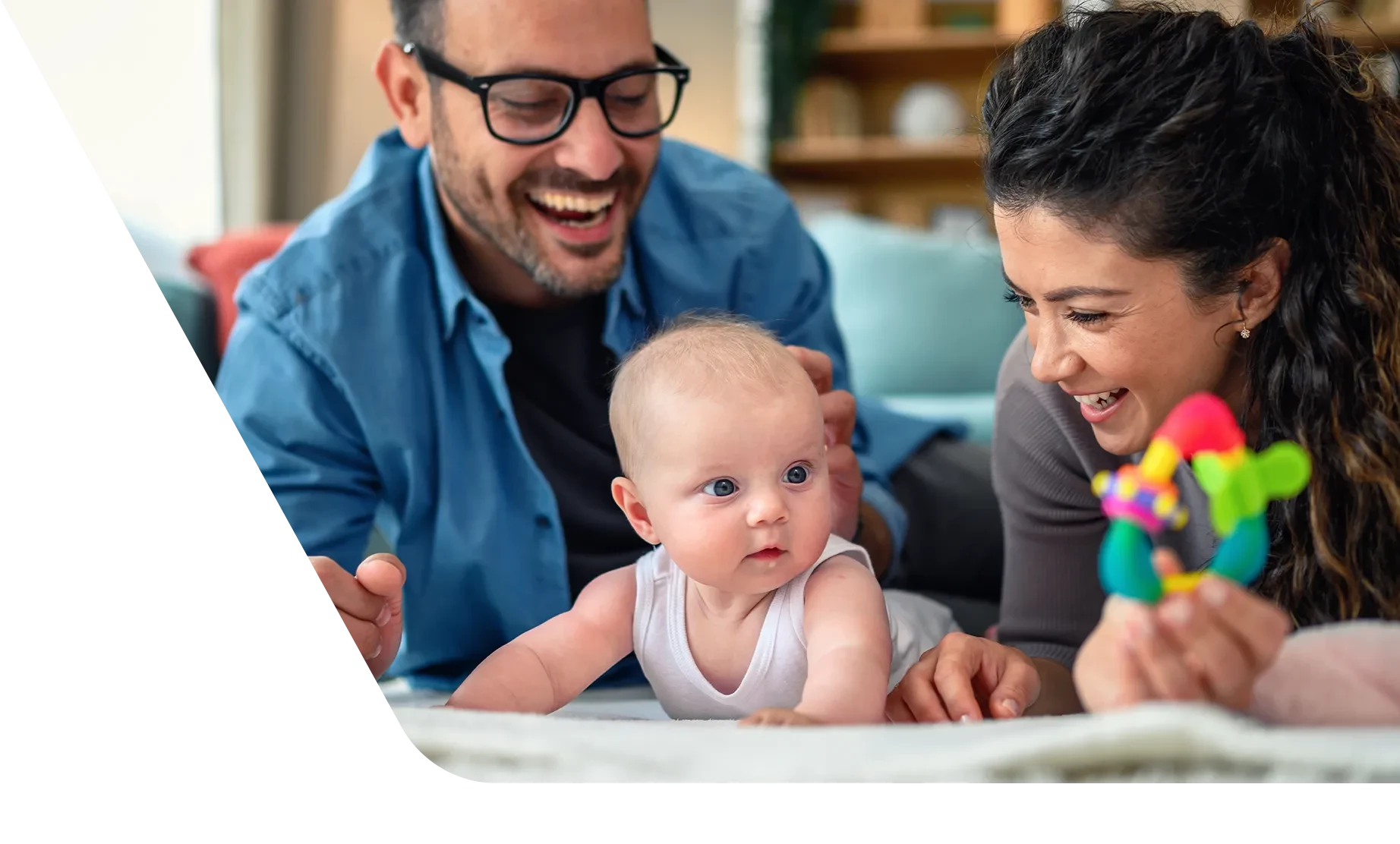 Dad and mom playing with baby during tummy time