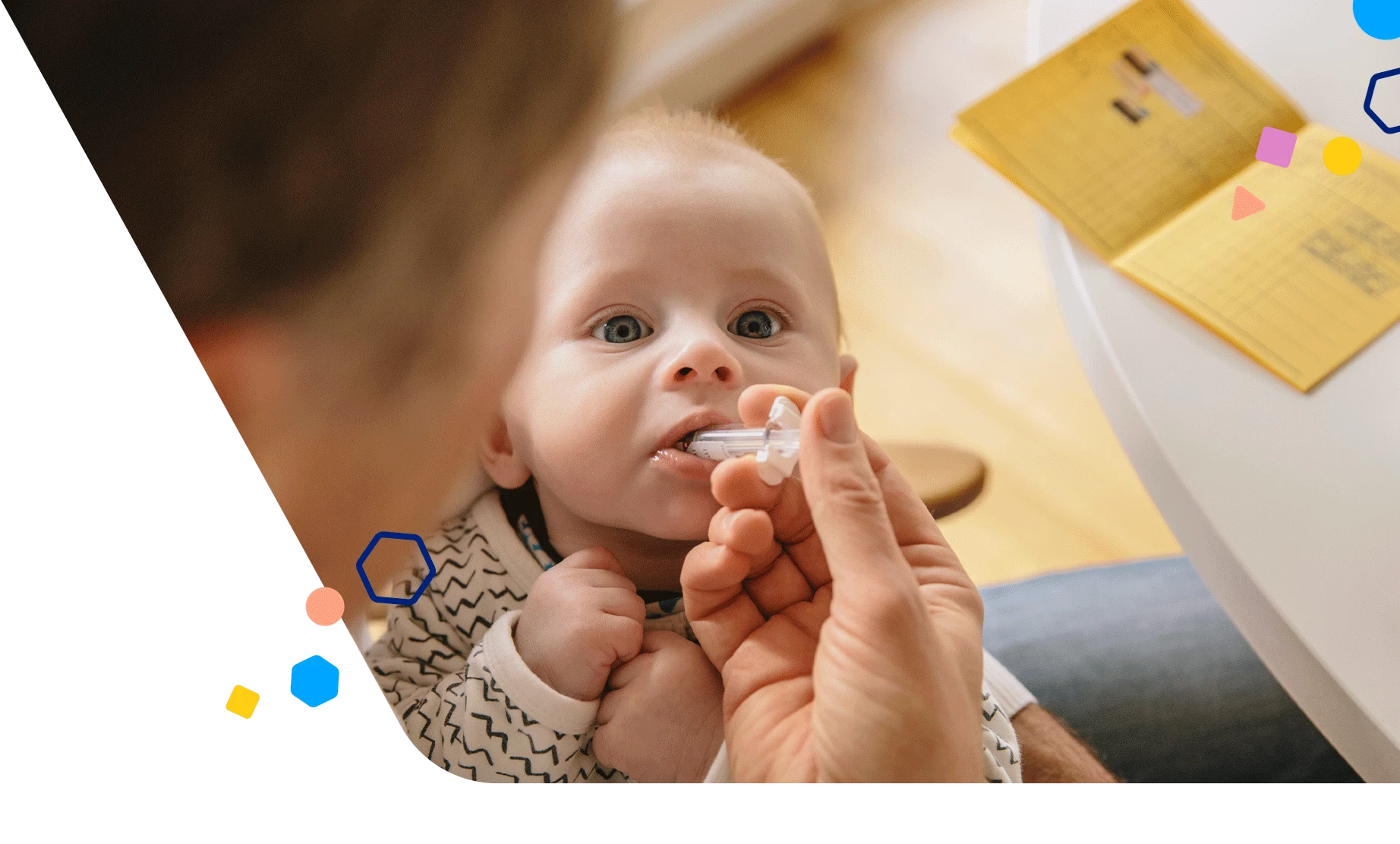 Parent giving baby vitamin drops