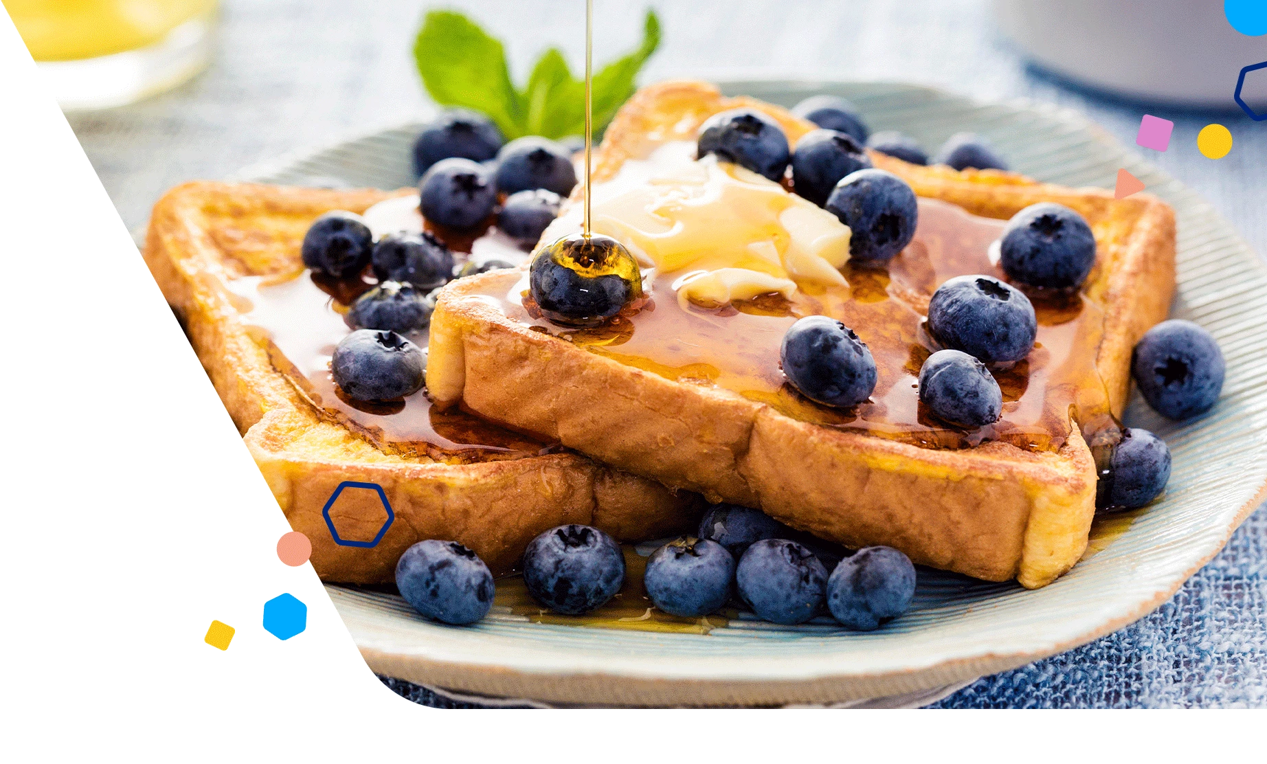 A plate of french toast topped with butter and blueberries