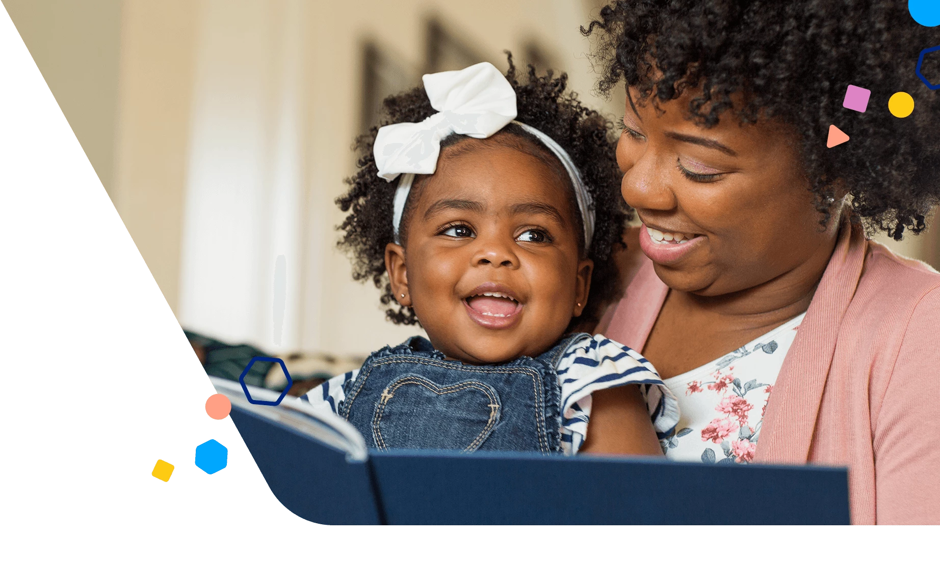 Mom reading book to happy toddler