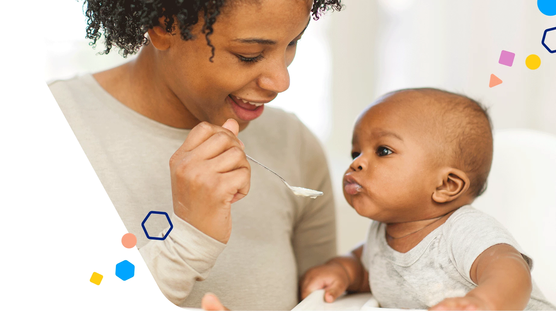 Mom spoon feeding infant