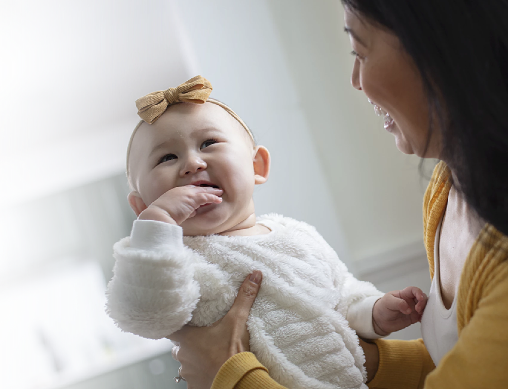 Mom holding smiling baby