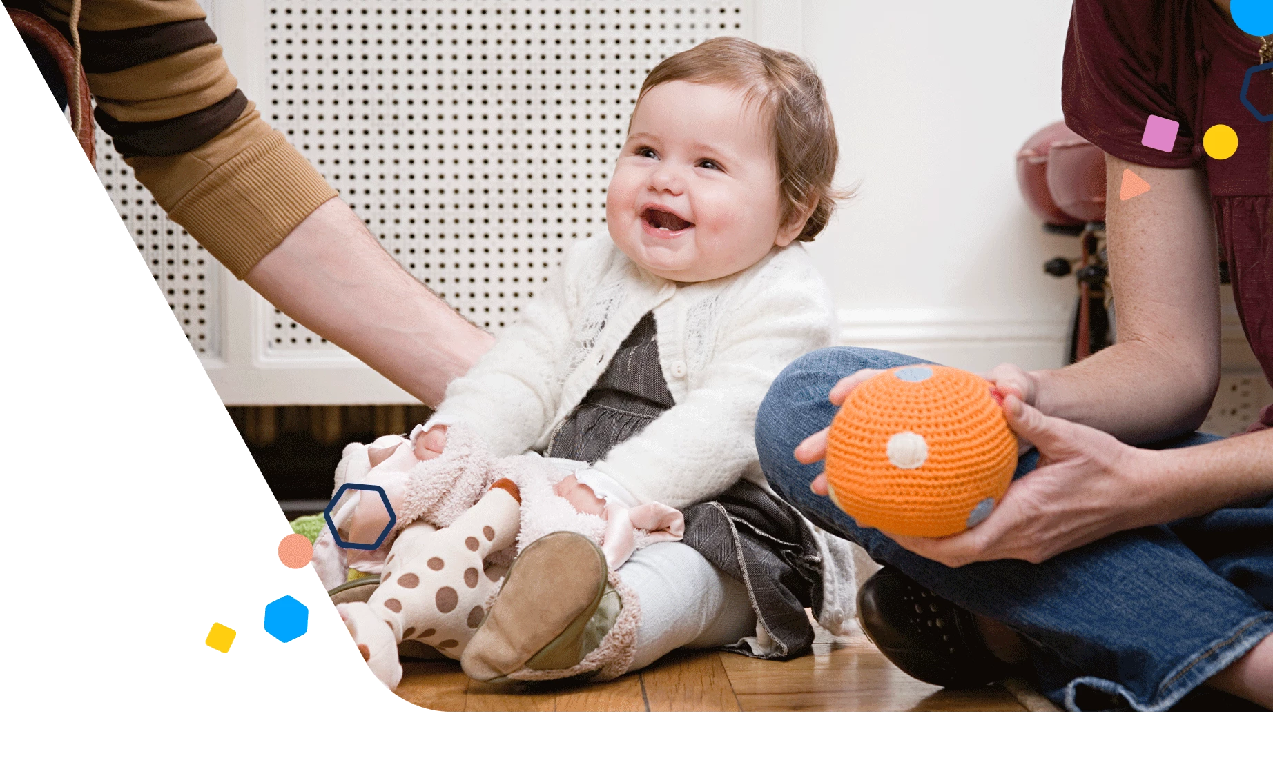 Parents and baby on the floor playing with toys