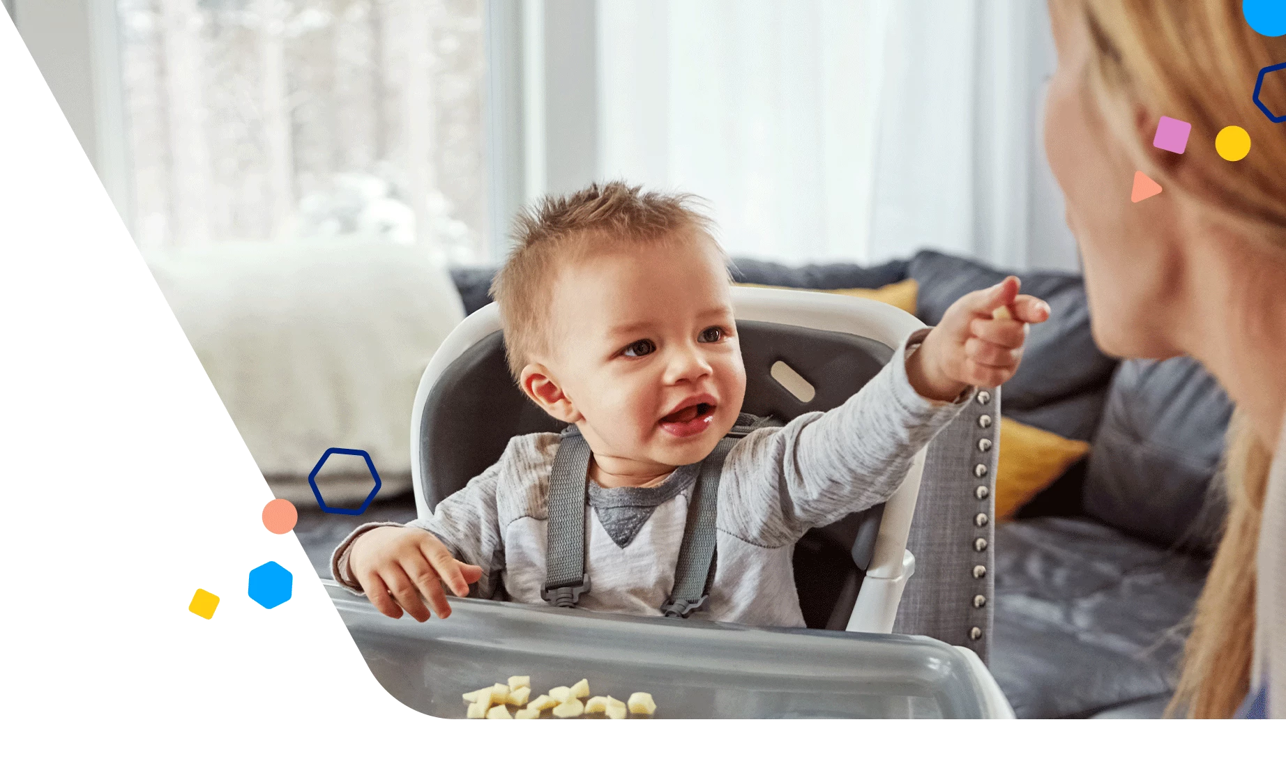 Toddler in a high chair offering food to mom