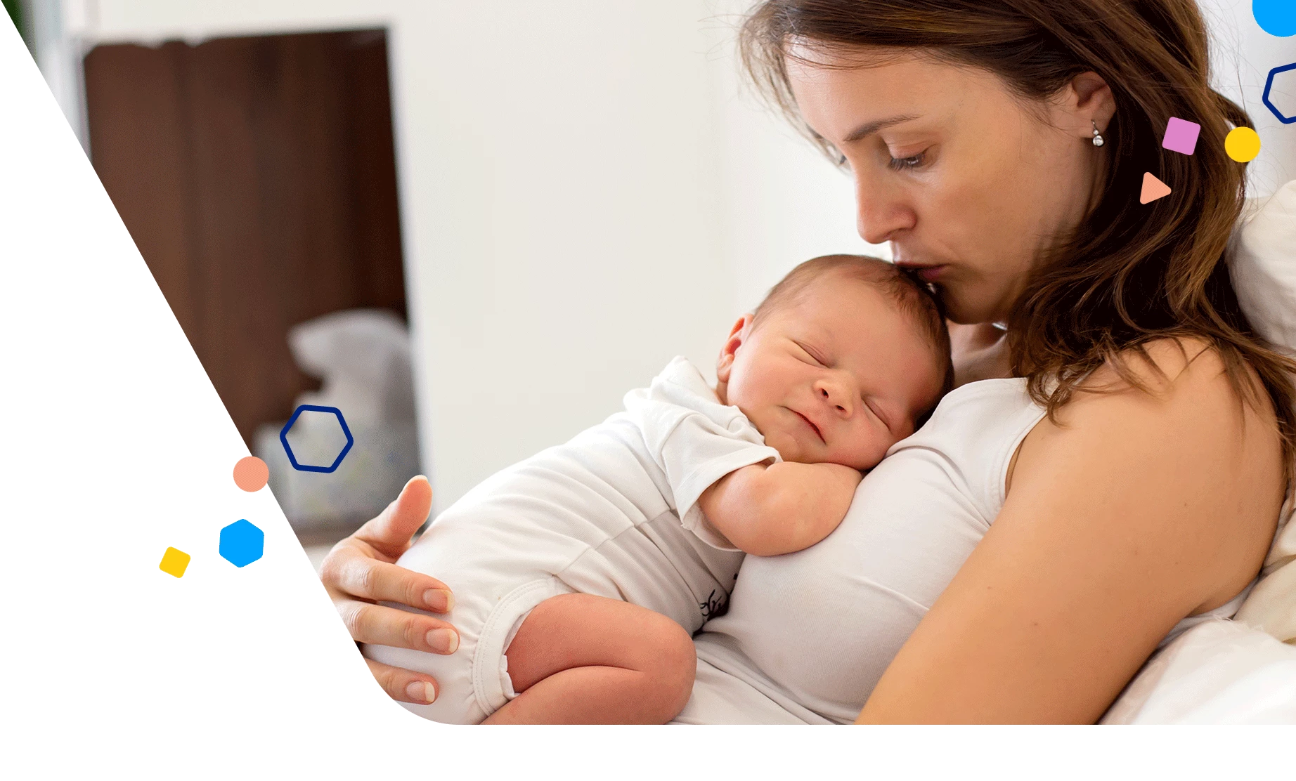 Mom sitting and holding her newborn against her chest