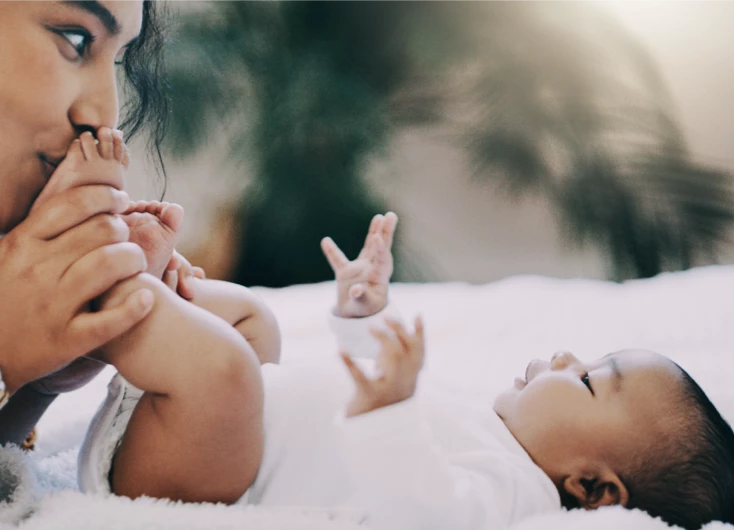 Mother kissing baby's feet