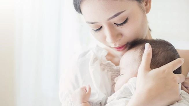 New mom holding her baby close