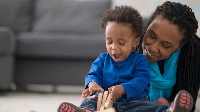 Mom and toddler playing on the floor