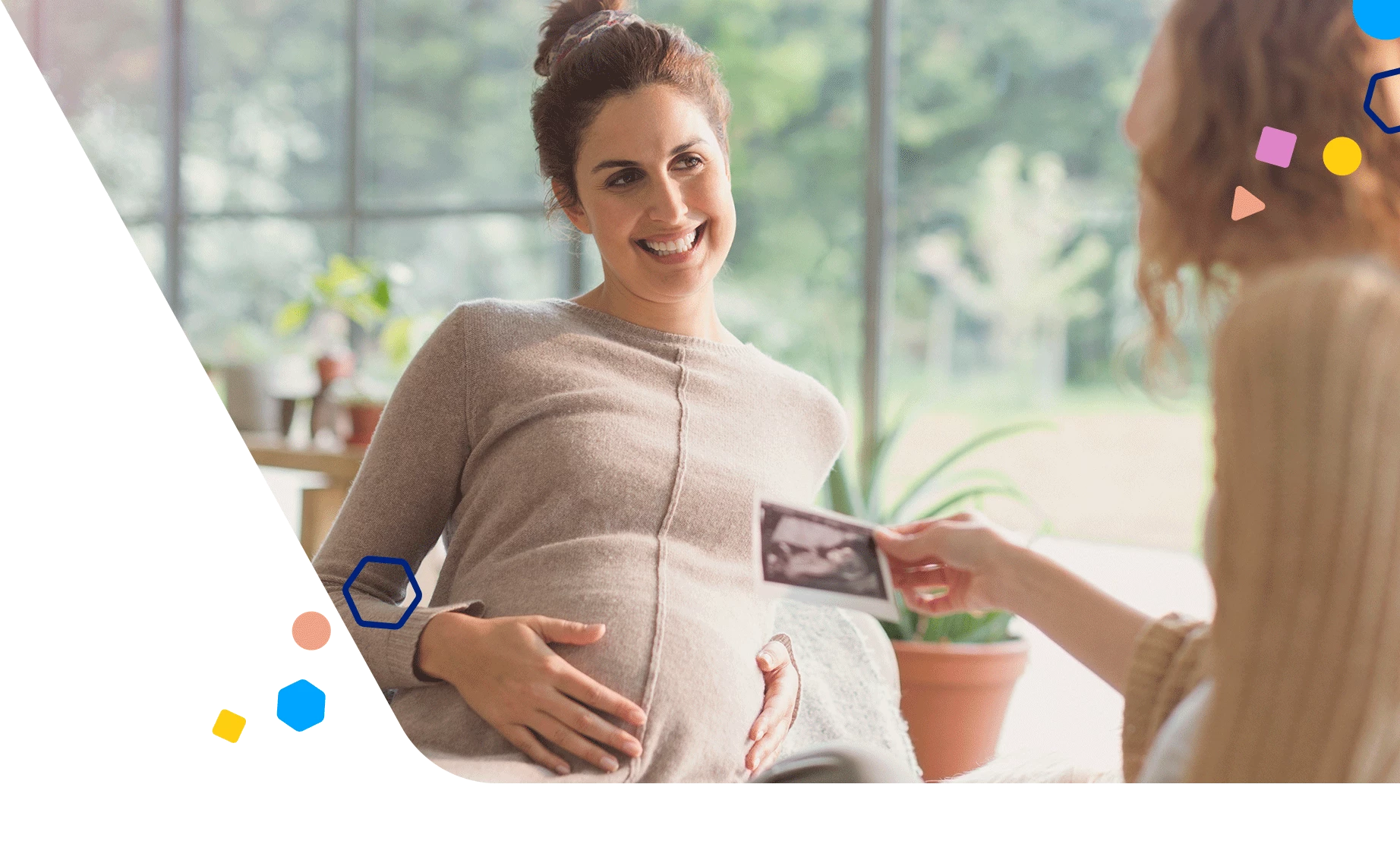 Pregnant woman showing her friend her ultrasound picture