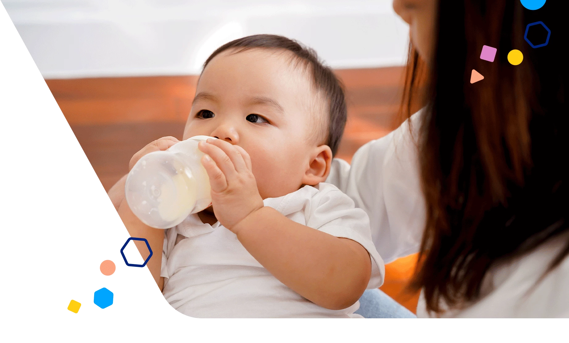 Mom holding baby as they drink a bottle