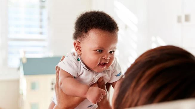 Mom holding 3 month old baby