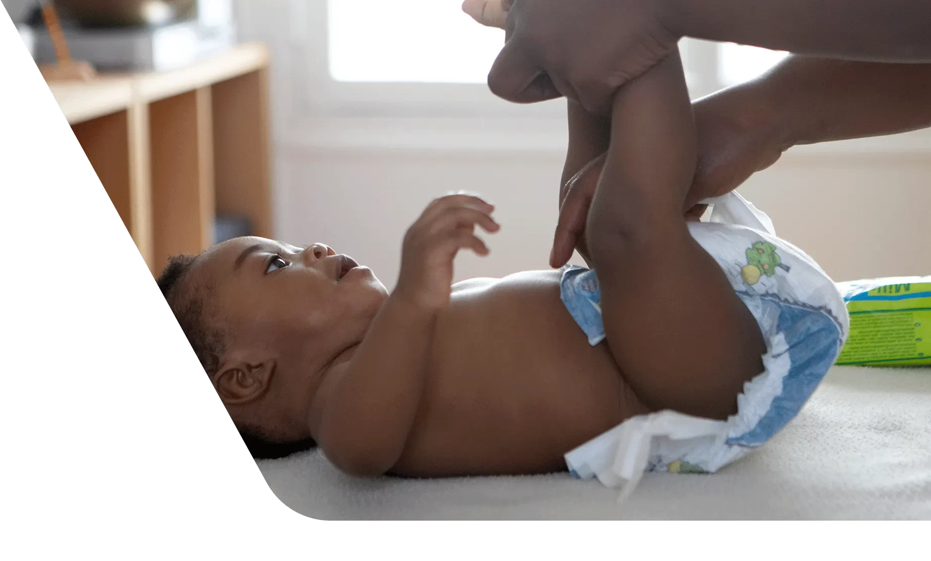 Mom changing baby's diaper