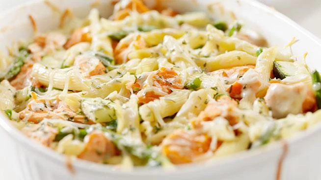 Close up of penne with salmon and roasted vegetables