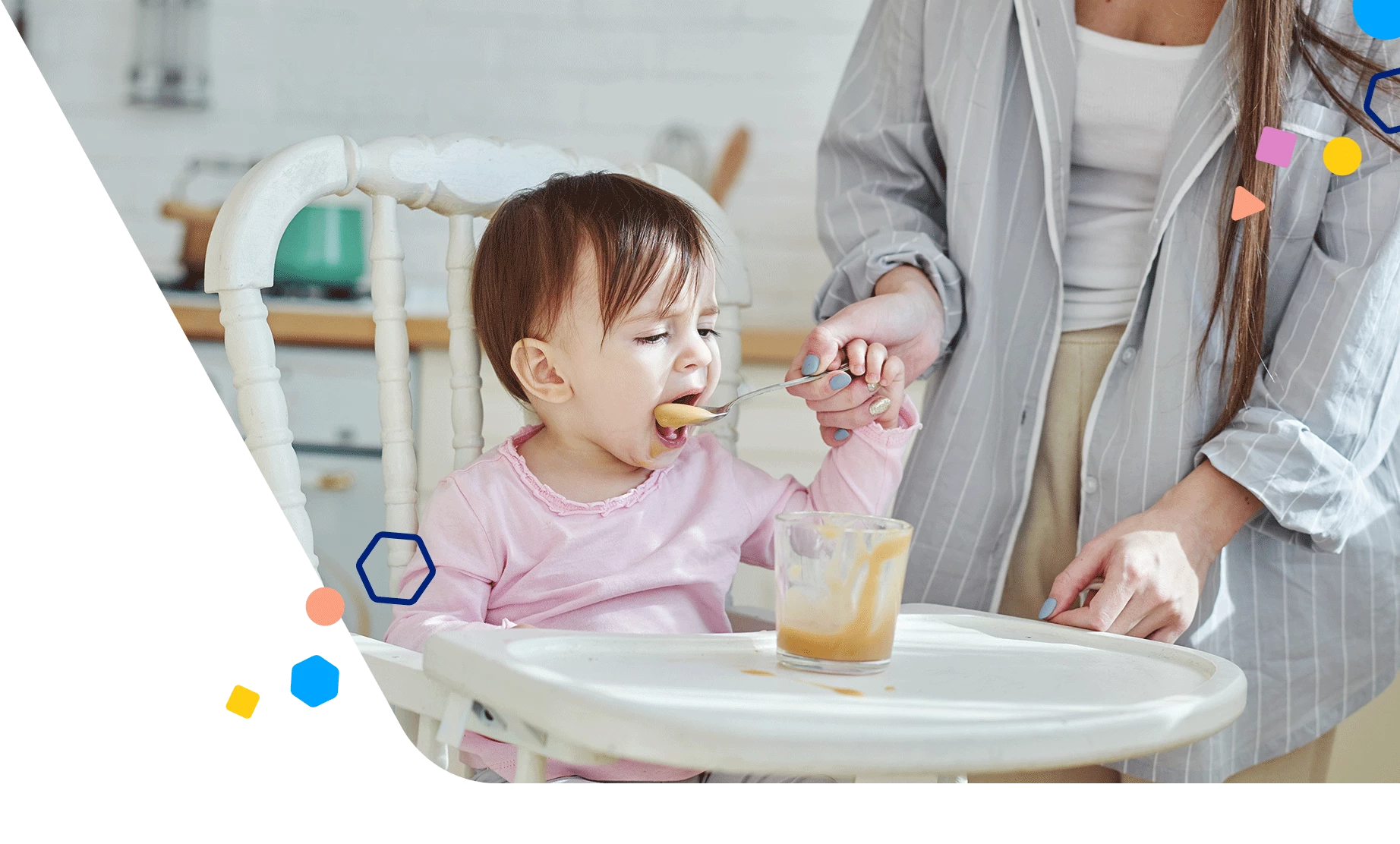 Toddler in a high chair eating with a spoon