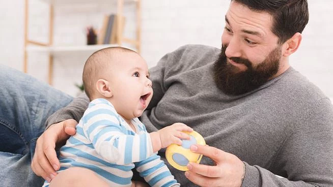 Dad and infant son playing with blocks