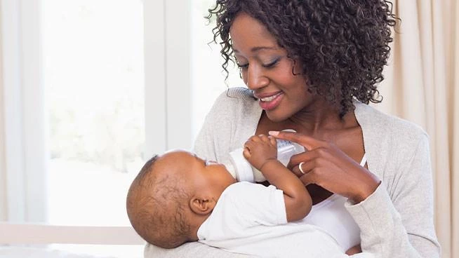 New mom bottle feeding her infant