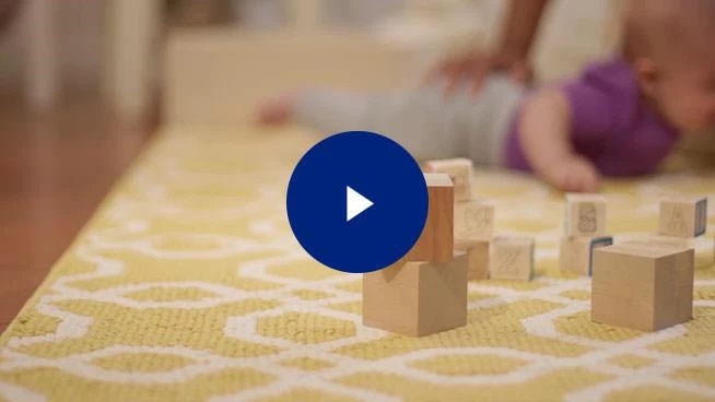 Baby blocks with play button overlay