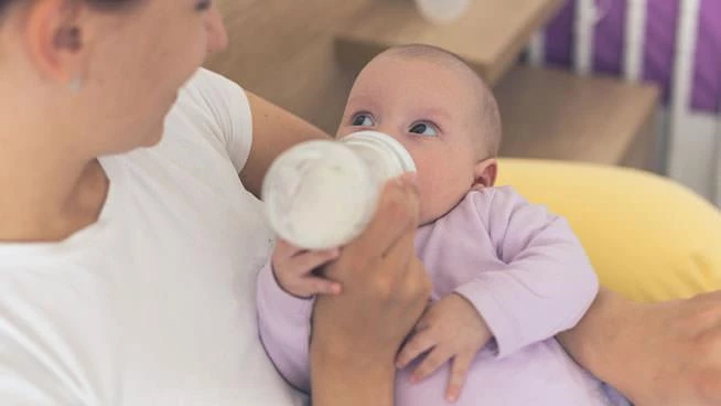 Mom bottle feeding baby