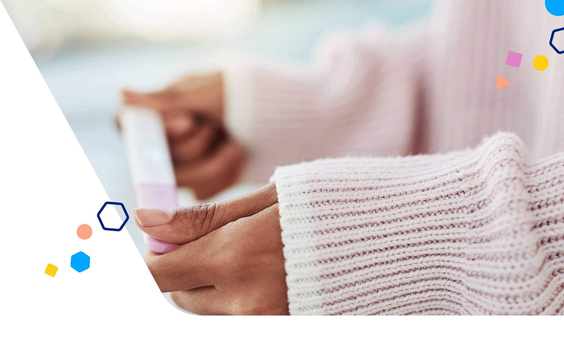 Close up of a woman holding a pregnancy test