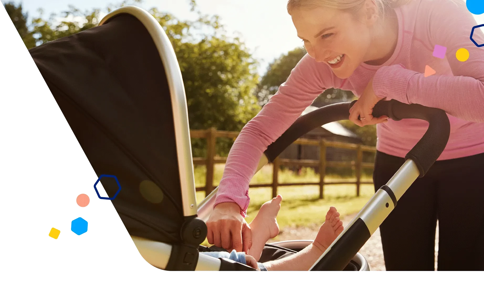 Mom pushing her baby in a stroller on a sunny day