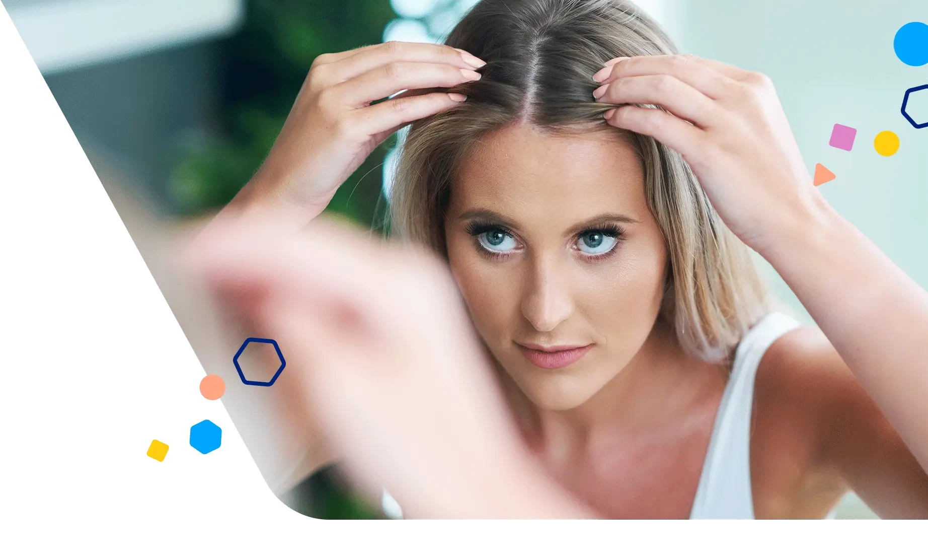 Woman looking closely at her hair in the mirror