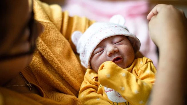 Young mom holding newborn baby