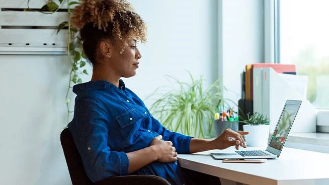 Pregnant woman working on her laptop