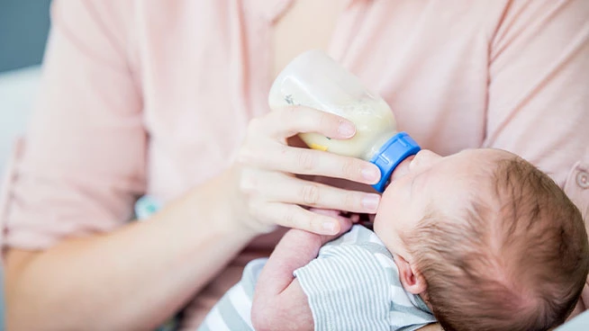 Parent bottle feeding premature baby