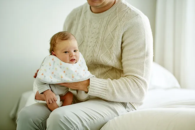 Father burping baby to soothe a stomach ache.