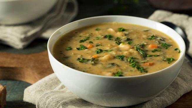 Creamy white bean soup with cabbage and salmon