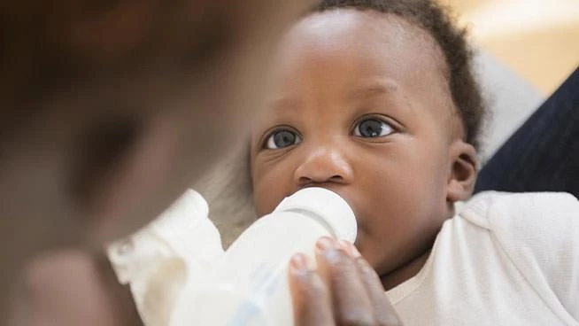 Mom bottle feeding baby