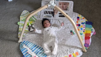 Baby laying on a floor mat 