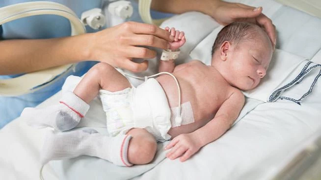 Newborn preemie being cared for in the NICU