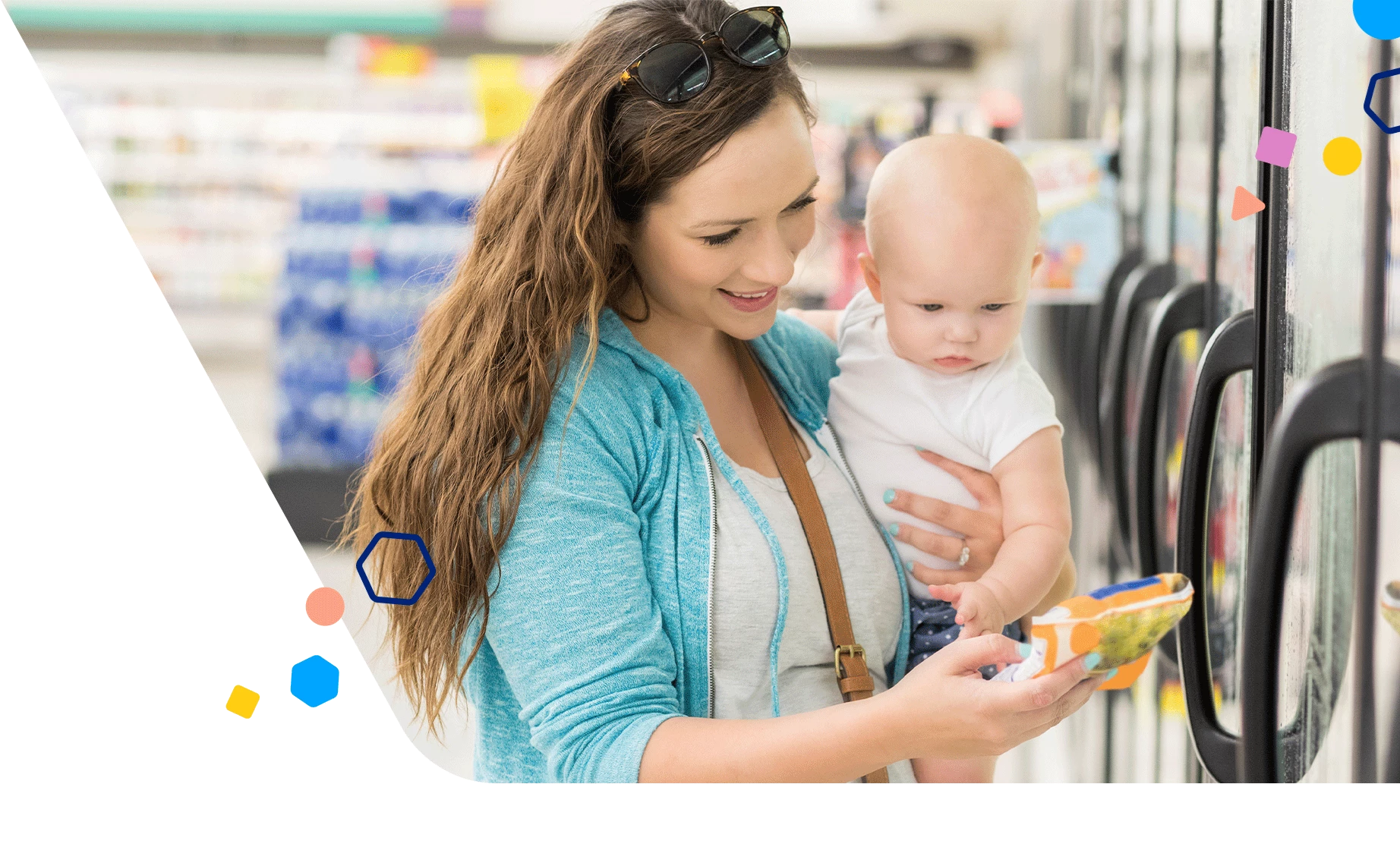 Mom and baby at the grocery store looking at frozen veggies