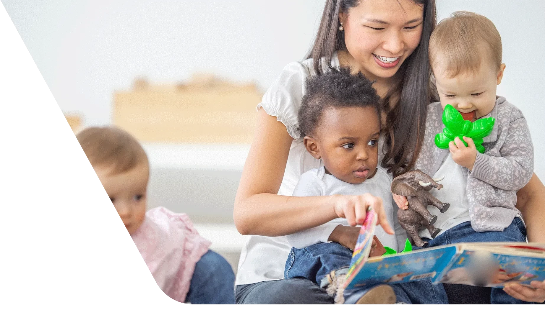 Daycare professional paying with group of toddlers