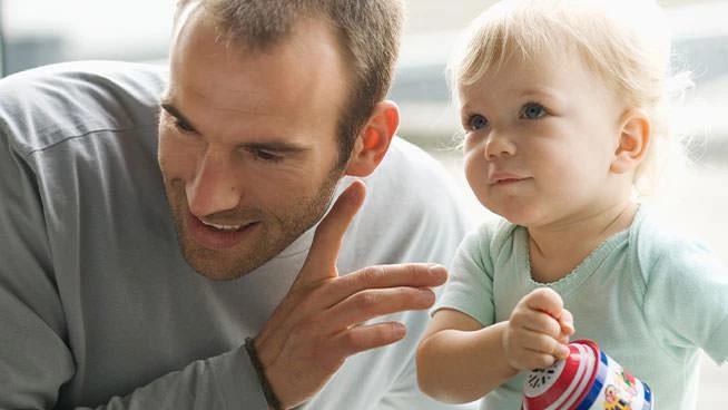 Dad and baby listening together