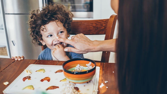 Toddler and mom sitting at the table together