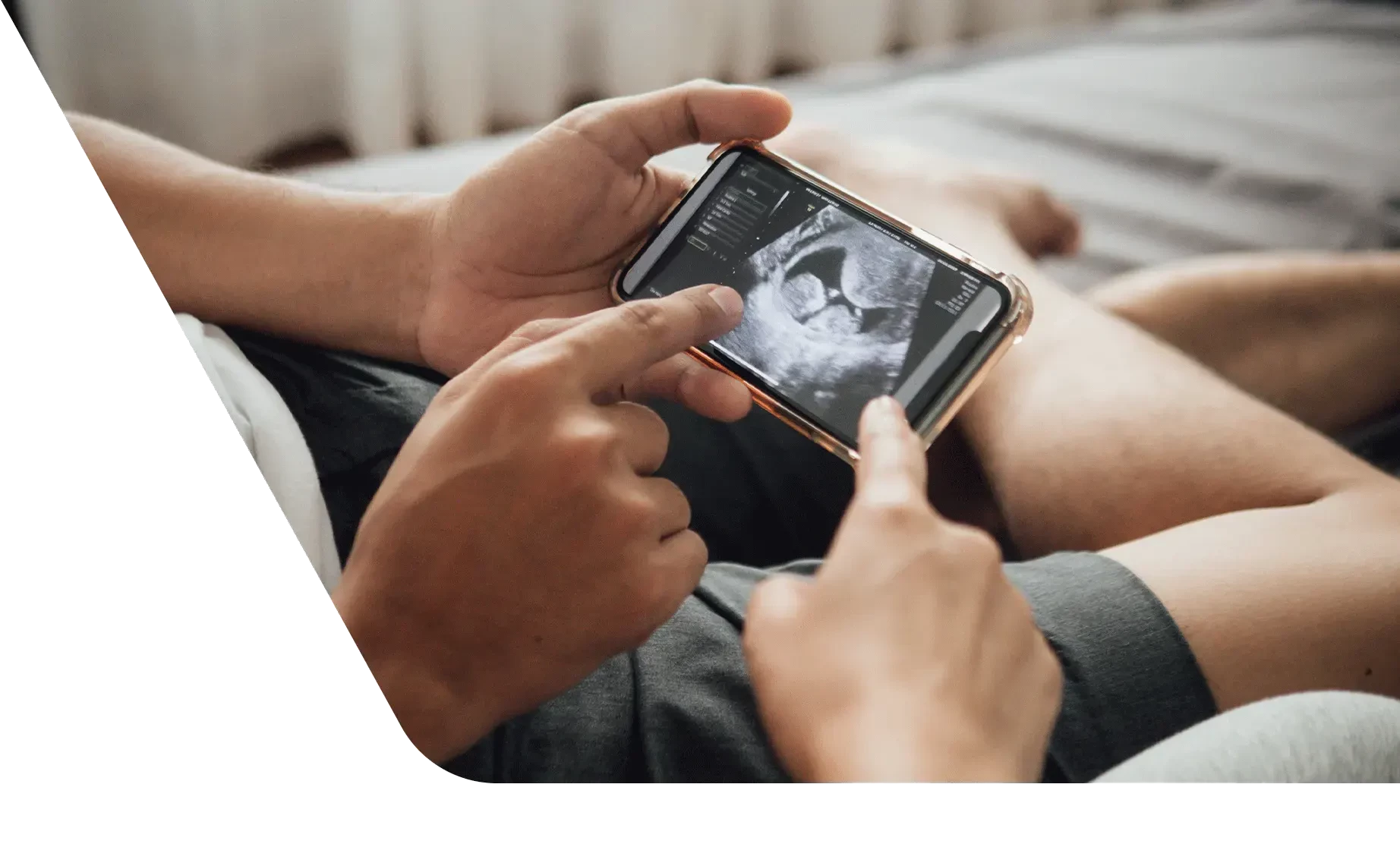 Couple looking at ultrasound image on phone