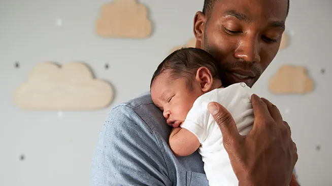 Dad holding premature baby