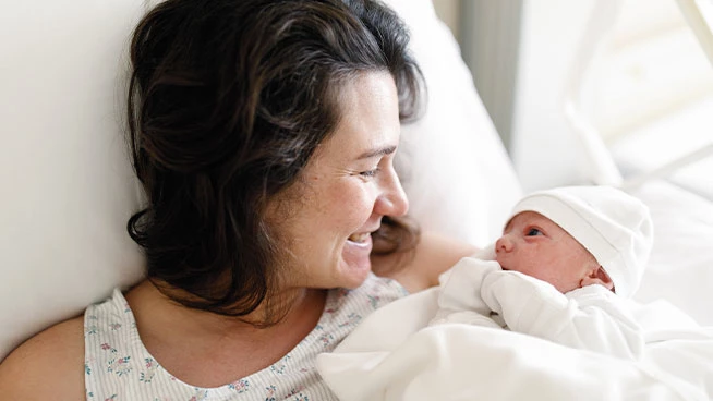 Mom holding newborn in the hospital