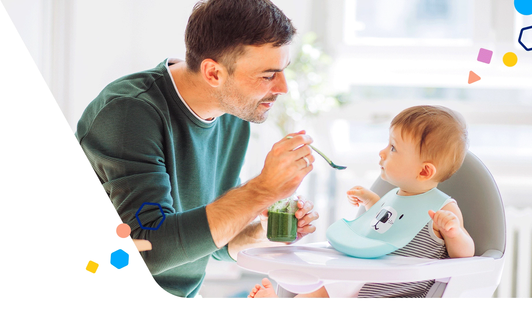 Dad feeding baby in high chair